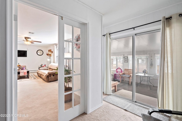 doorway with carpet floors, visible vents, a ceiling fan, french doors, and baseboard heating