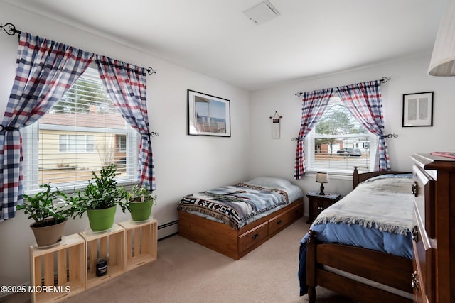 bedroom with carpet, multiple windows, and a baseboard radiator