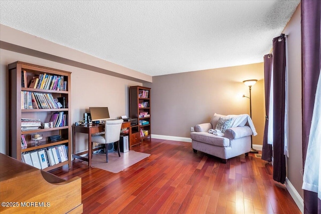 office space featuring a textured ceiling, baseboards, and dark wood-type flooring