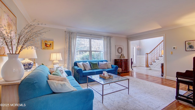 living room featuring crown molding and light hardwood / wood-style floors