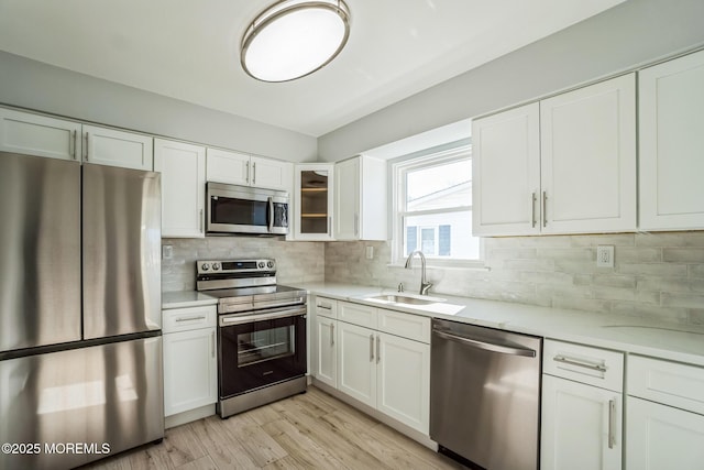 kitchen featuring a sink, appliances with stainless steel finishes, and white cabinetry