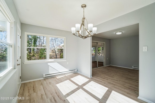 unfurnished dining area with wood finished floors, baseboards, a baseboard heating unit, a notable chandelier, and baseboard heating