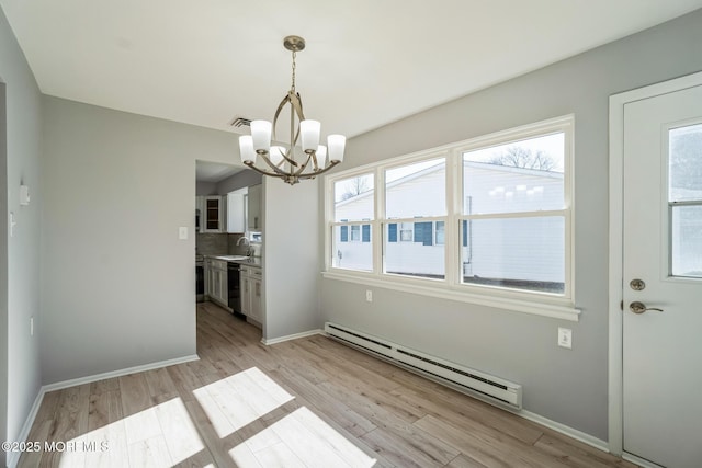 unfurnished dining area with light wood-type flooring, baseboards, baseboard heating, and an inviting chandelier