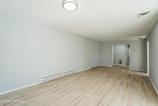 spare room with light wood-style floors, visible vents, baseboards, and baseboard heating