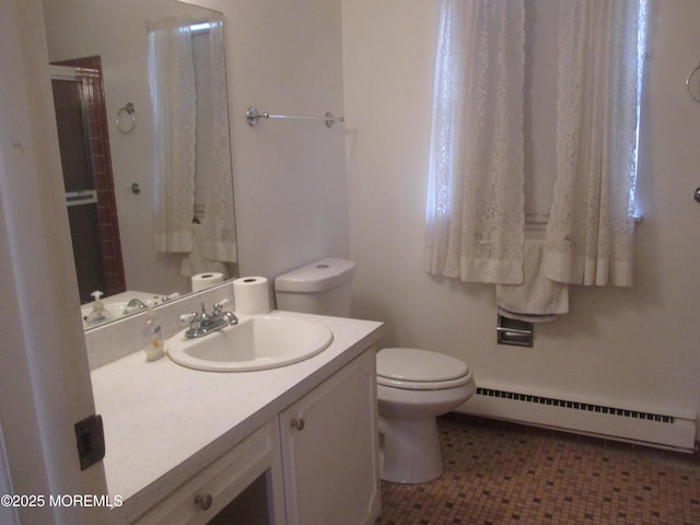 bathroom with a shower with shower door, tile patterned floors, a baseboard heating unit, toilet, and vanity