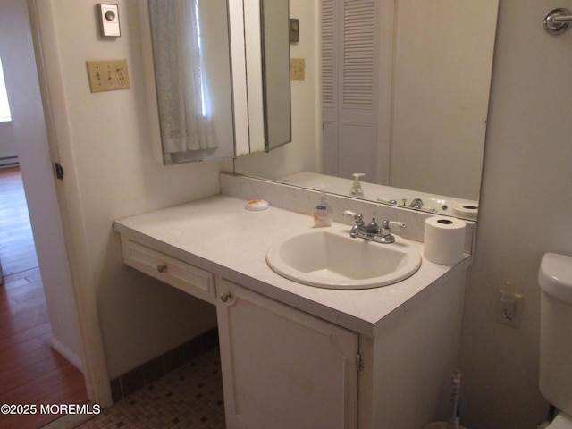 bathroom featuring toilet and vanity