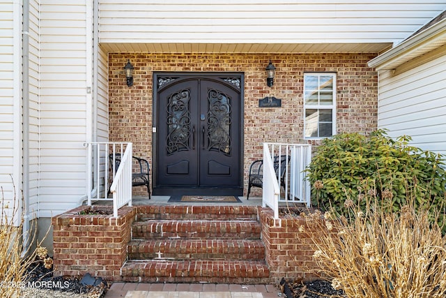 entrance to property with french doors and brick siding