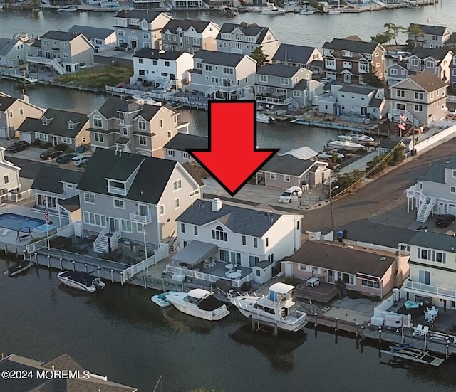 drone / aerial view featuring a water view and a residential view