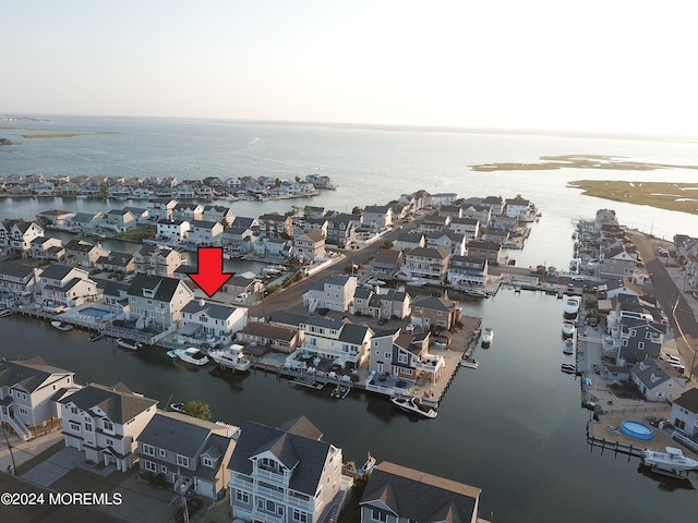 drone / aerial view featuring a residential view and a water view