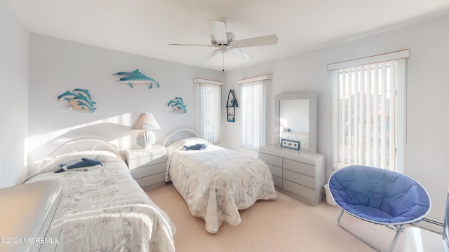 bedroom with ceiling fan and light colored carpet