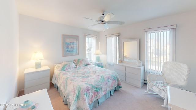 carpeted bedroom featuring ceiling fan and a baseboard radiator