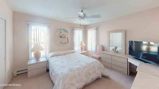 bedroom with baseboard heating, ceiling fan, and light carpet