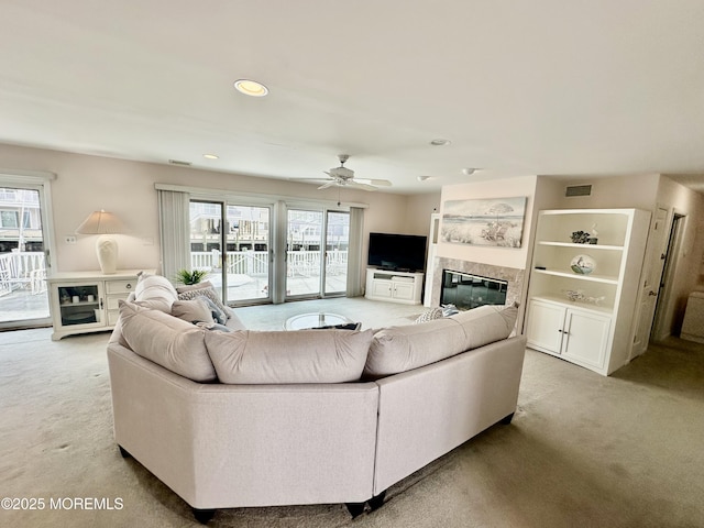 carpeted living room featuring ceiling fan