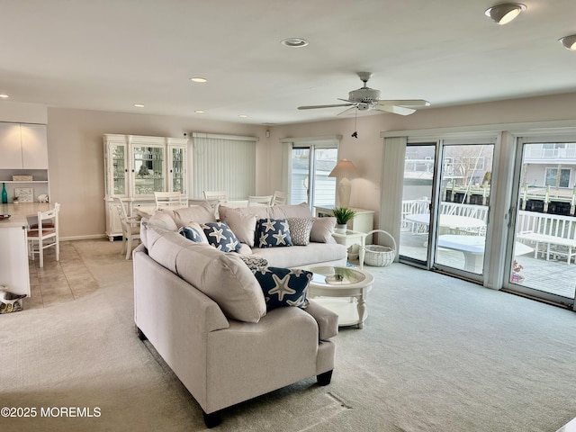 living room featuring light colored carpet and ceiling fan