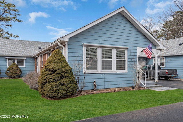 bungalow-style home featuring a front yard