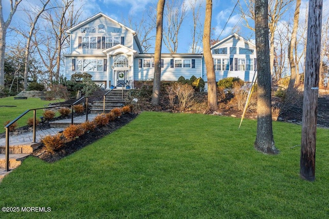 view of property featuring a front lawn