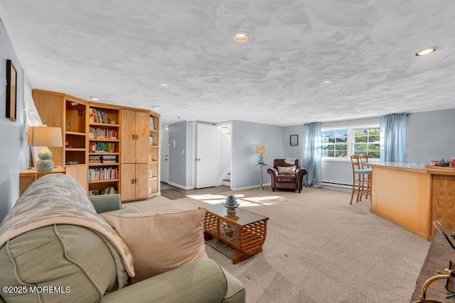 living area featuring baseboards, stairs, light carpet, a textured ceiling, and a baseboard heating unit