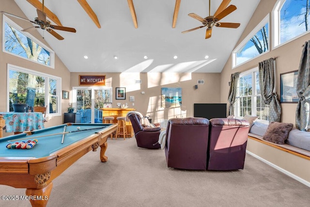 recreation room with high vaulted ceiling, light colored carpet, and bar