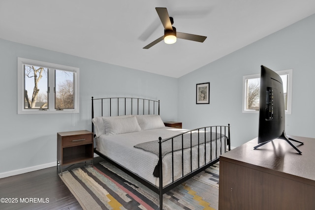 bedroom featuring lofted ceiling, a ceiling fan, baseboards, and dark wood-style flooring