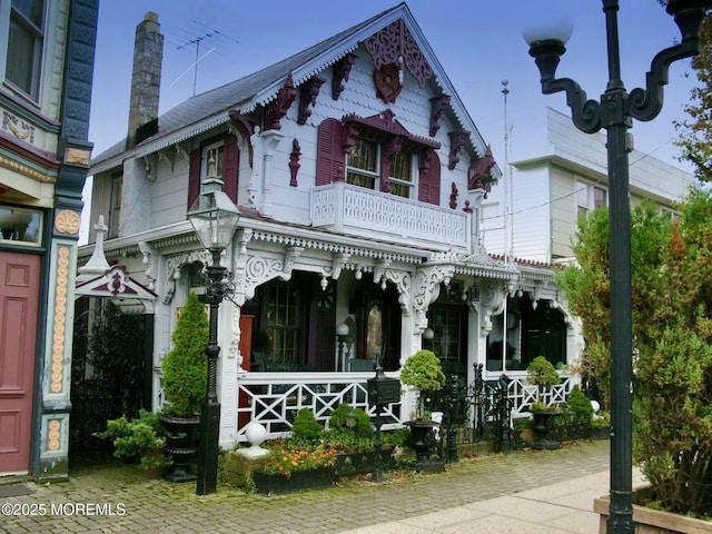 view of front of house with a balcony and a porch