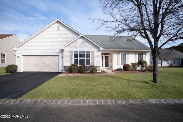 ranch-style house with an attached garage, aphalt driveway, and a front yard