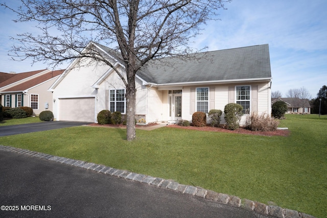 view of front of property with aphalt driveway, a garage, a shingled roof, and a front lawn