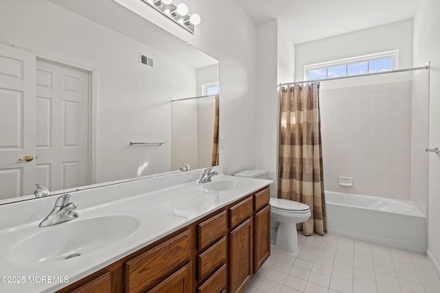 bathroom featuring shower / bath combo with shower curtain, tile patterned flooring, a sink, and visible vents