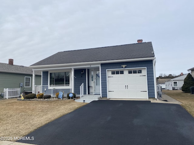 ranch-style house with driveway, covered porch, an attached garage, and a shingled roof