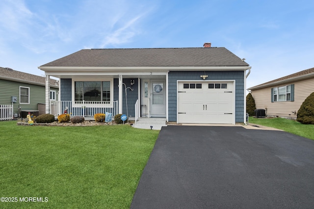 view of front facade featuring covered porch, central AC, a garage, driveway, and a front lawn