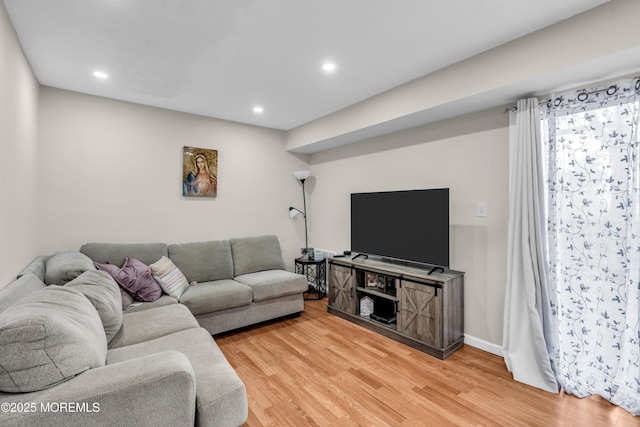 living room with baseboards, wood finished floors, and recessed lighting