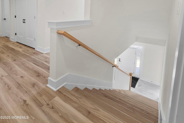 stairs with hardwood / wood-style flooring