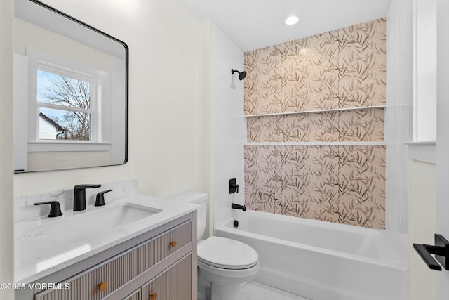 full bathroom featuring toilet, vanity, and tiled shower / bath