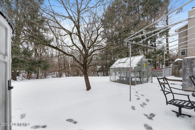 yard layered in snow featuring an outbuilding