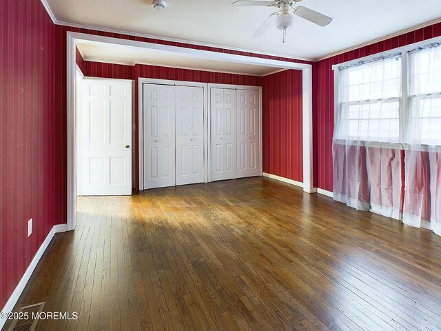 78 Lake Ave, Ocean Grove, NJ 07756 - unfurnished bedroom featuring ornamental molding, hardwood / wood-style floors, multiple closets, and baseboards