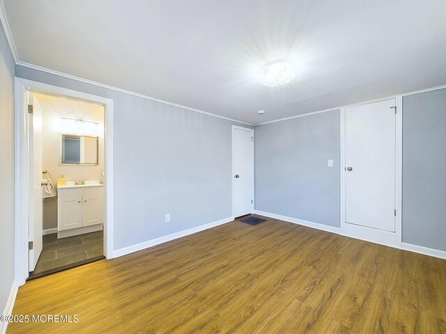 78 Lake Ave, Ocean Grove, NJ 07756 - unfurnished bedroom featuring crown molding, a sink, ensuite bath, wood finished floors, and baseboards