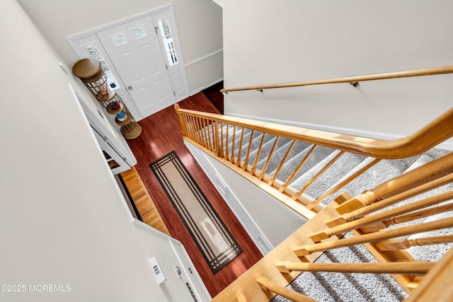 stairs featuring hardwood / wood-style flooring