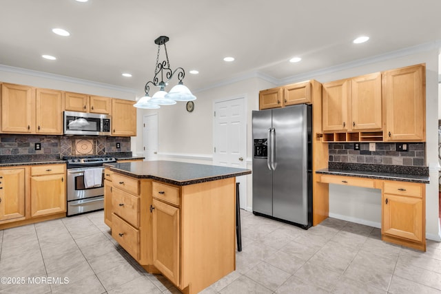 kitchen featuring built in desk, stainless steel appliances, decorative light fixtures, crown molding, and a center island