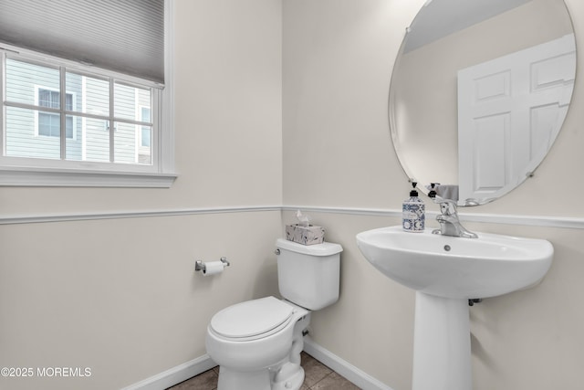 bathroom with toilet and tile patterned flooring