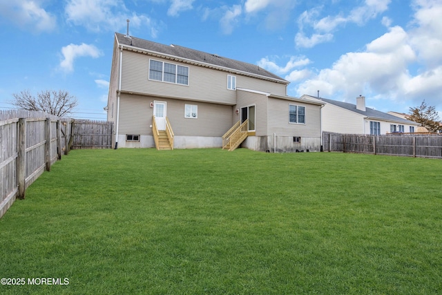 rear view of house with a yard