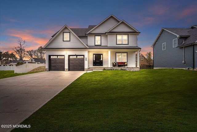 view of front of house featuring covered porch, a garage, fence, driveway, and a lawn