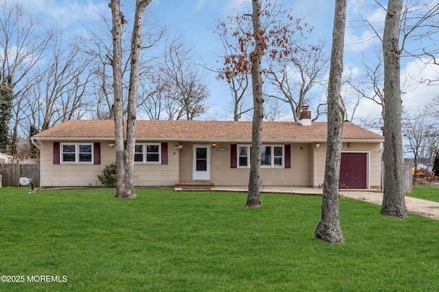 ranch-style home with a garage and a front lawn