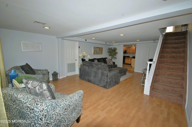 living room featuring recessed lighting, stairs, visible vents, and wood finished floors