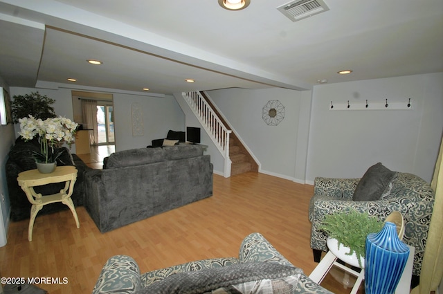 living area featuring recessed lighting, stairs, visible vents, and wood finished floors