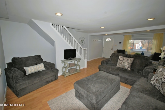 living area with stairs, recessed lighting, and wood finished floors