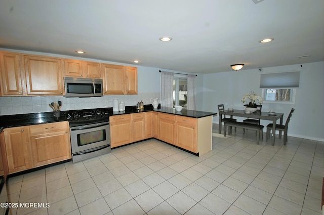 kitchen featuring light tile patterned floors, recessed lighting, backsplash, stainless steel appliances, and a peninsula