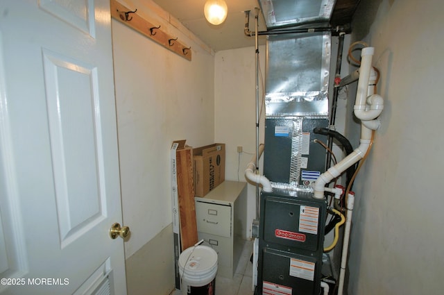 utility room featuring heating unit