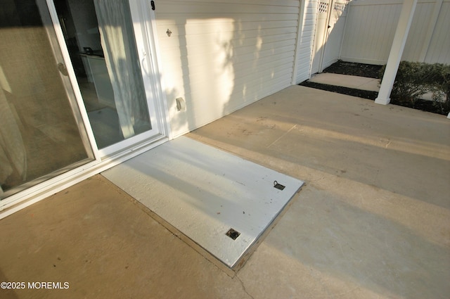 view of patio featuring fence