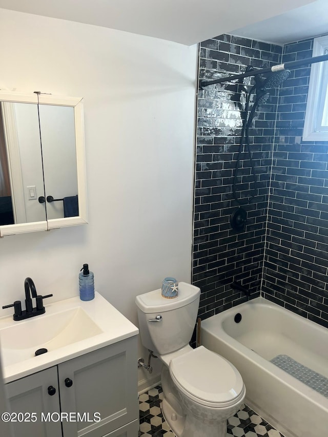 full bathroom featuring tiled shower / bath combo, vanity, and toilet