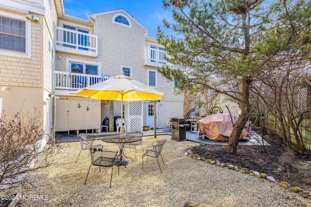 back of house with a balcony and a patio area