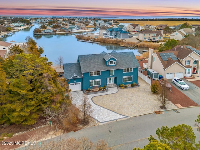 view of front of house with a water view